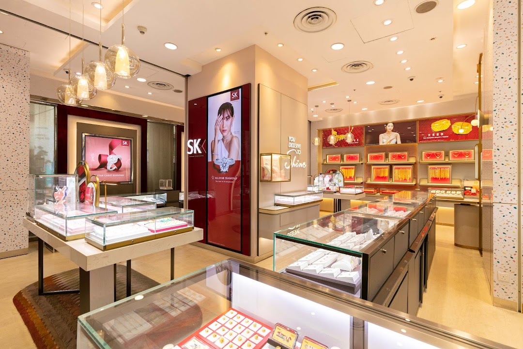 Interior view of SK Jewellery shop showcasing display cases filled with various jewellery pieces and promotional screens.
