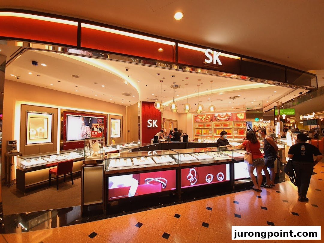 Interior view of SK Jewellery showcasing display cases with customers browsing exquisite jewelry.
