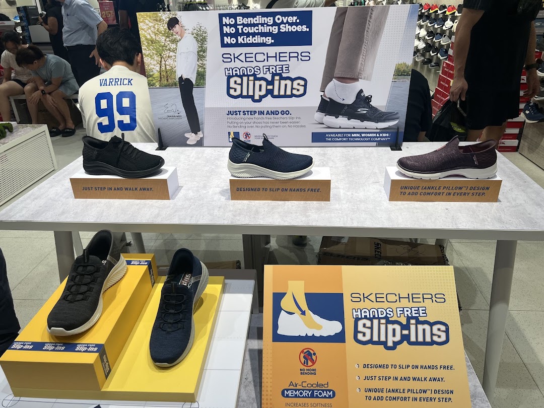 A Skechers store display featuring various 'Hands Free Slip-ins' shoes and promotional signage.
