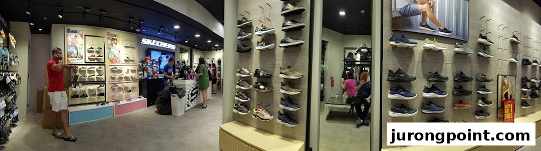 Interior view of a Skechers shoe store, showcasing various footwear on display and customers browsing.