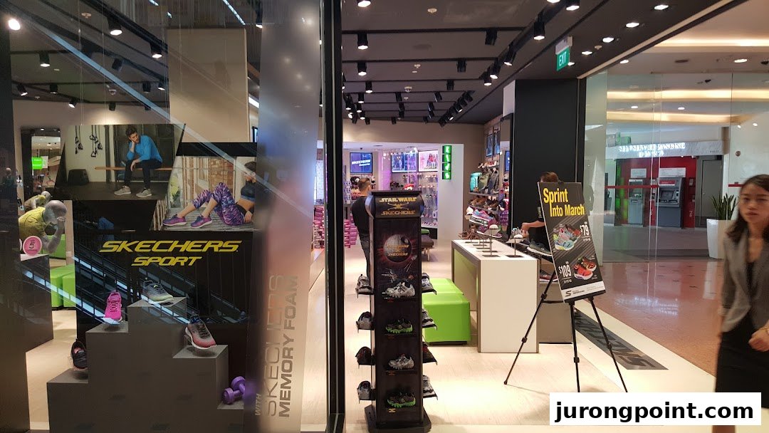 The Skechers store entrance features a vibrant display of athletic footwear and a view into the spacious interior.