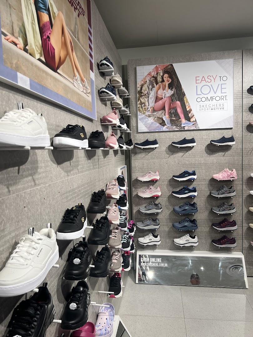 An interior view of a Skechers store showcasing various shoe styles displayed on wall racks.