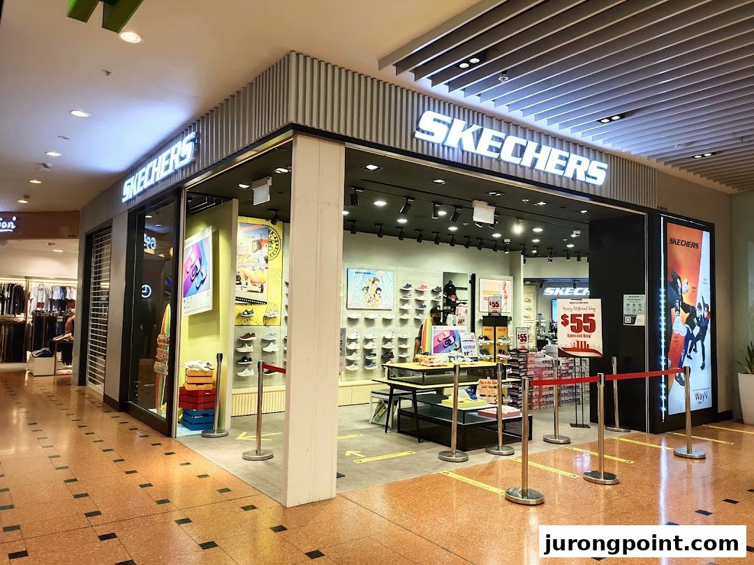 The brightly lit Skechers storefront in a shopping mall, showcasing its entrance and interior displays.