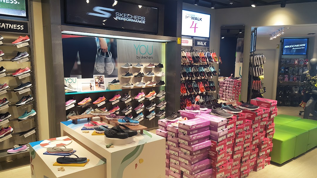 An interior view of a Skechers store showcasing a wide variety of athletic and casual footwear.