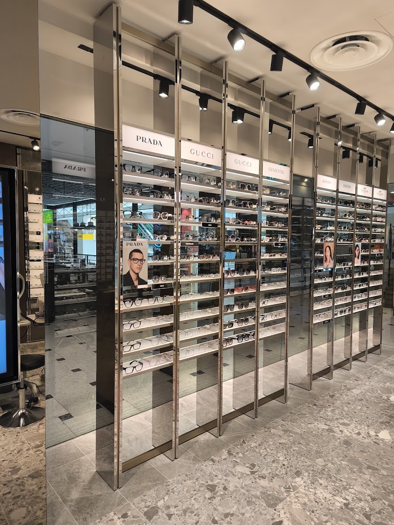 Interior view of Spectacle Hut showcasing rows of designer eyeglasses and sunglasses on display shelves.