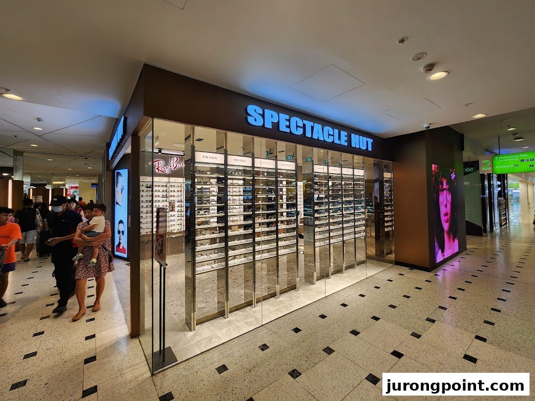 The Spectacle Hut storefront showcases a wide array of eyewear and sunglasses in a modern mall setting.