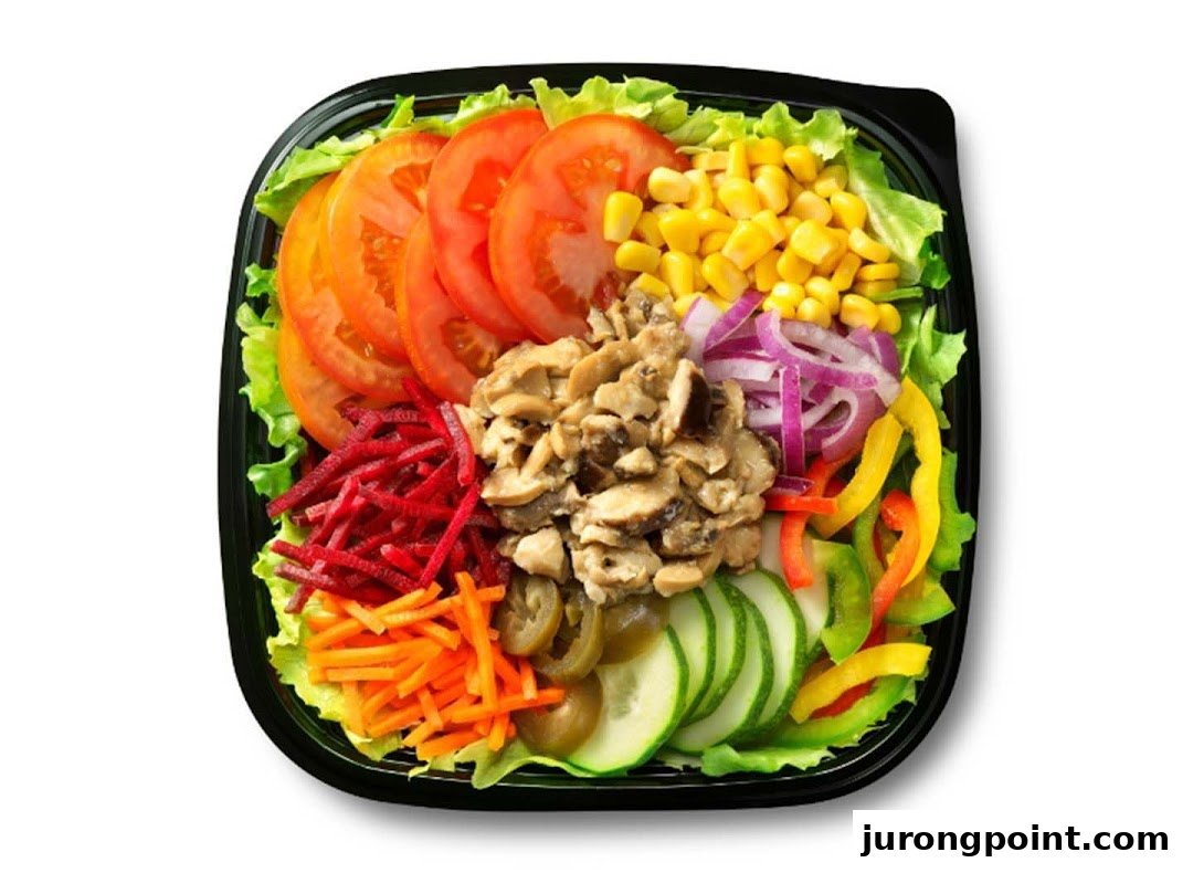 A vibrant, fresh salad in a black bowl, featuring various colorful vegetables and mushrooms.