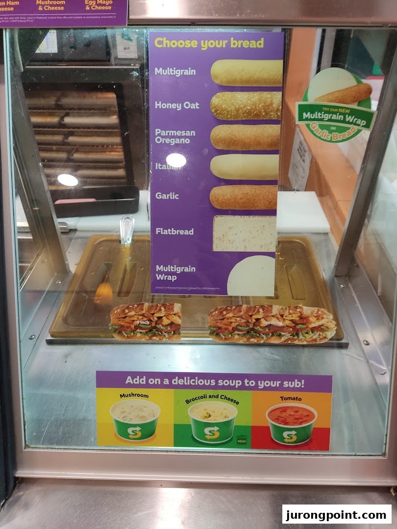 A Subway display case showcasing bread options, wraps, and soup choices.