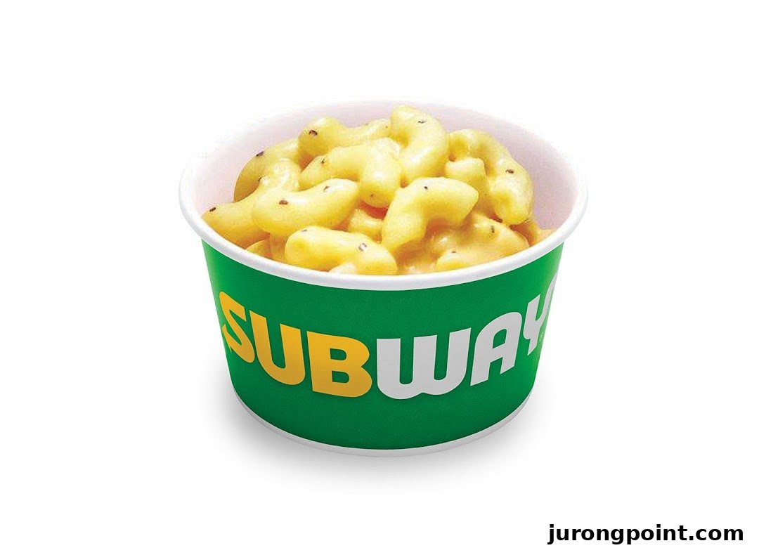 A cup of Subway's macaroni and cheese, featuring the brand's green and yellow logo.