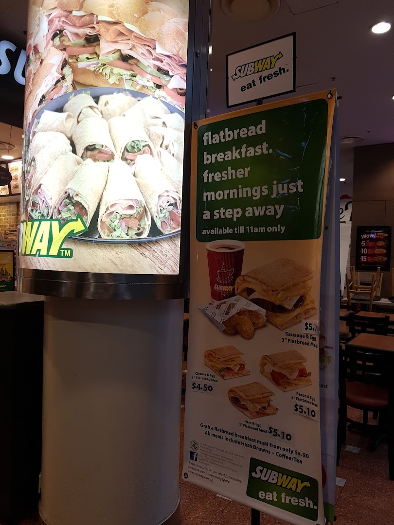 A promotional display for Subway's flatbread breakfast meals, featuring images of food and pricing.