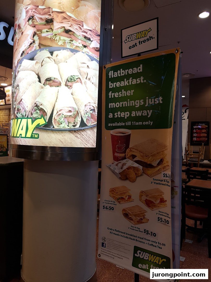 A promotional display for Subway's flatbread breakfast meals, featuring images of food and pricing.