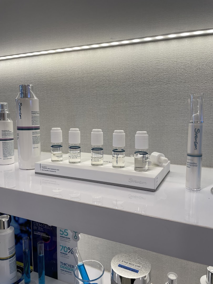 A display of Svenson hair loss and scalp treatment products on a white shelf.