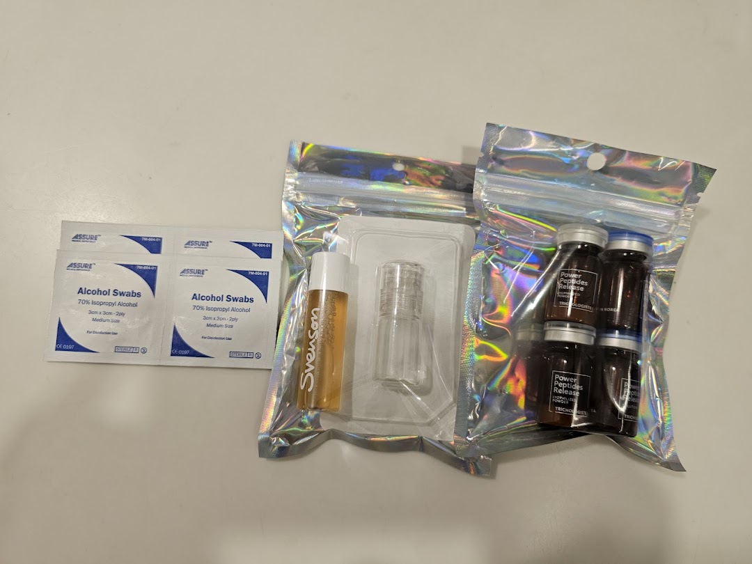 An assortment of hair treatment products including Svenson branded items, peptide vials, and alcohol swabs.