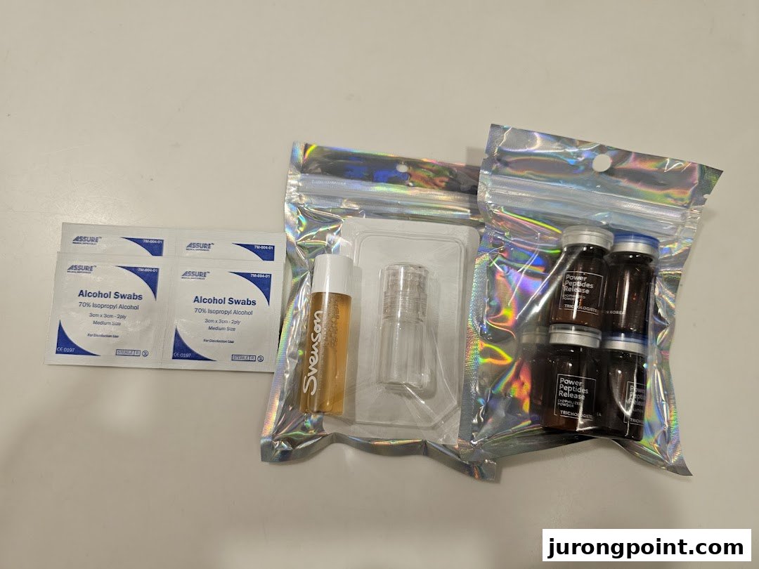 An assortment of hair treatment products including Svenson branded items, peptide vials, and alcohol swabs.