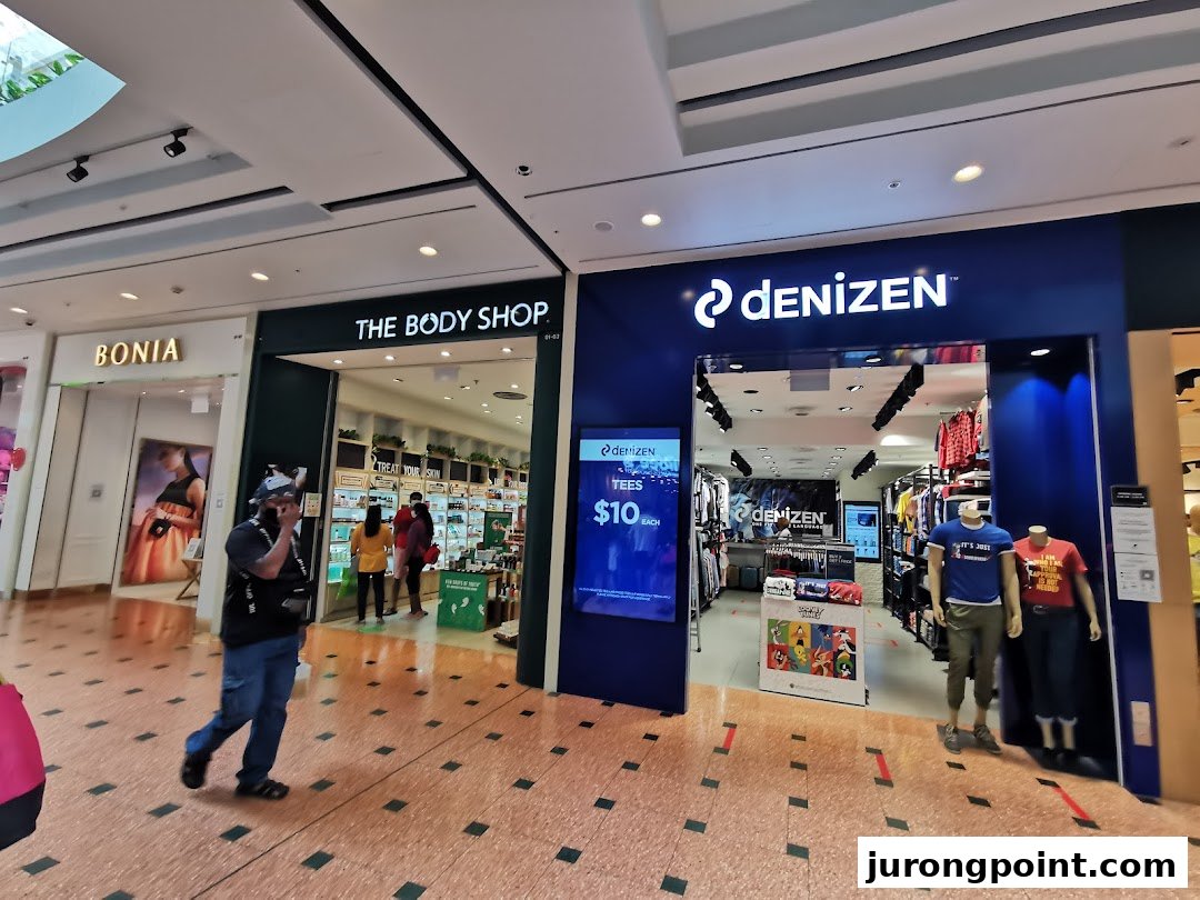 View of The Body Shop and Denizen storefronts within a bustling shopping mall.