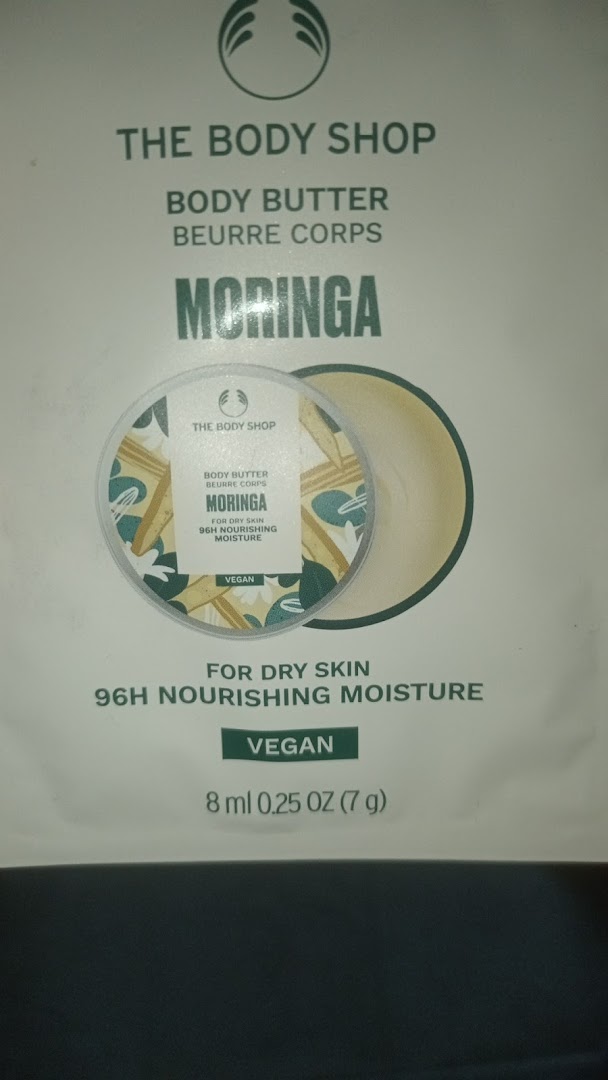 Close-up of The Body Shop's Moringa Body Butter packaging, highlighting its vegan and nourishing properties.