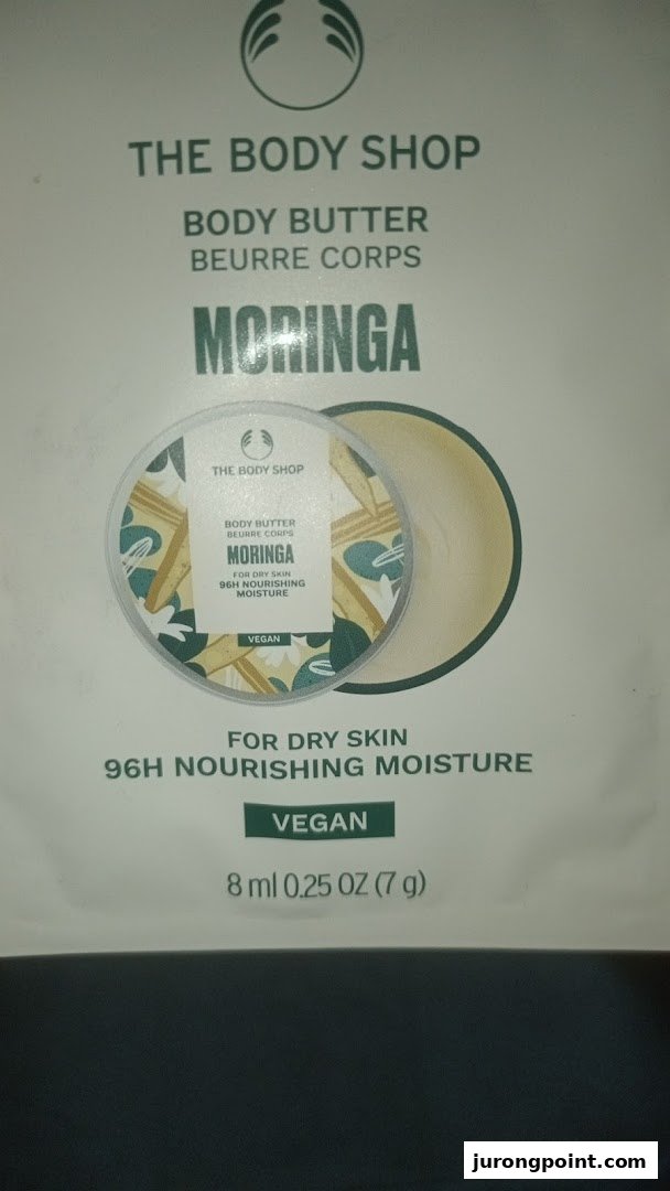 Close-up of The Body Shop's Moringa Body Butter packaging, highlighting its vegan and nourishing properties.