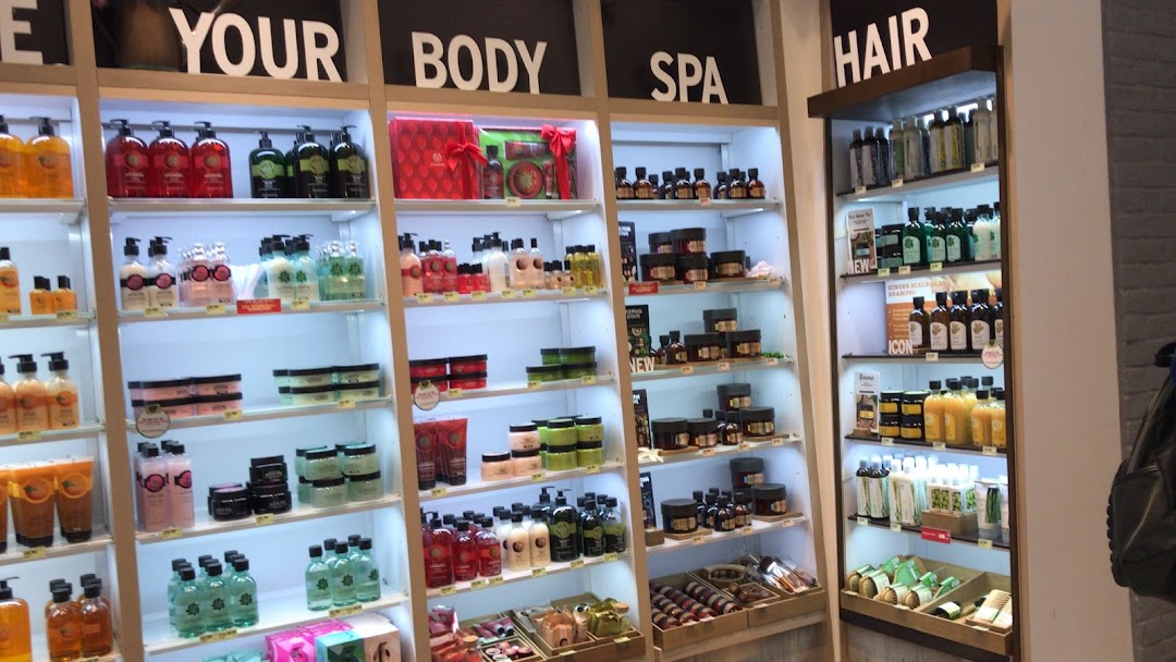 Brightly lit shelves display a wide array of The Body Shop's body, spa, and hair care products.