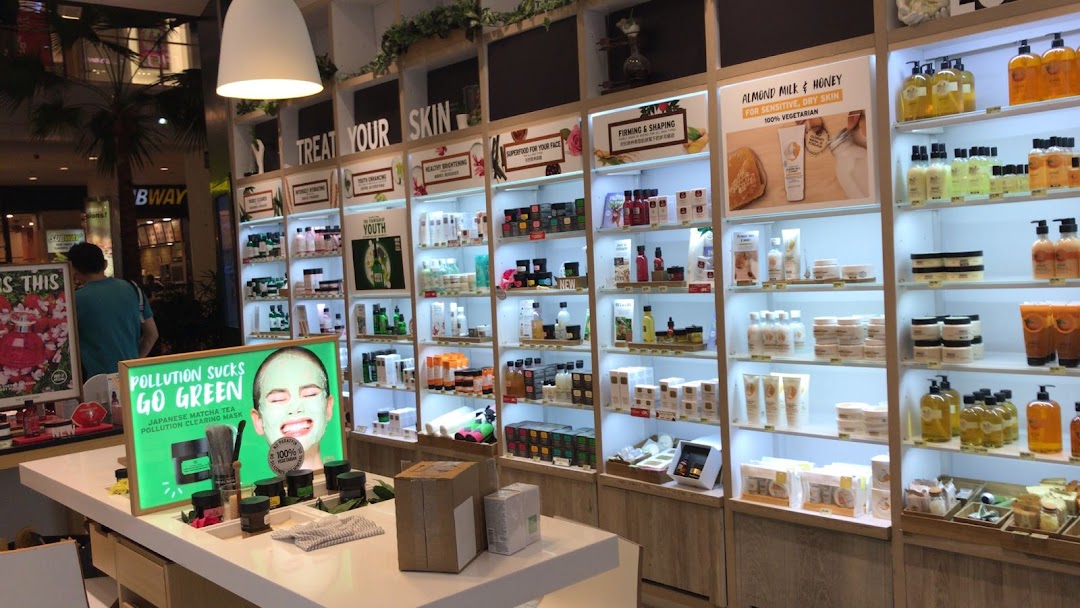 Interior view of The Body Shop, showcasing various skincare and beauty products on brightly lit shelves.