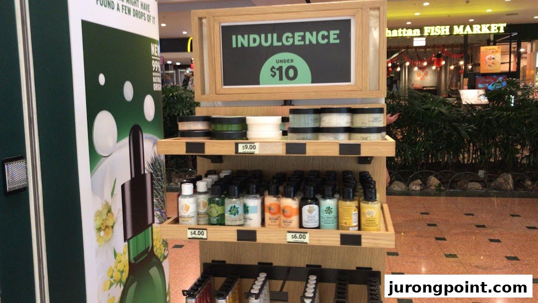 A retail display from The Body Shop featuring skincare products and an 'Indulgence Under $10' promotion.