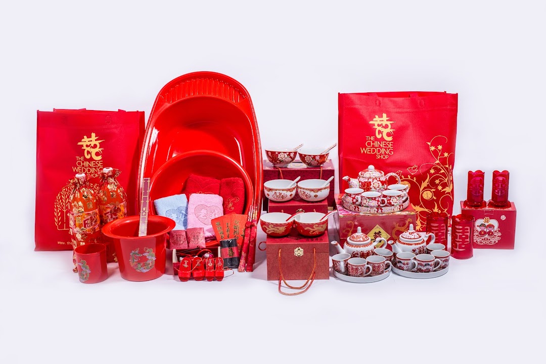 A comprehensive collection of traditional red Chinese wedding items, including tea sets, basins, and decorative elements.