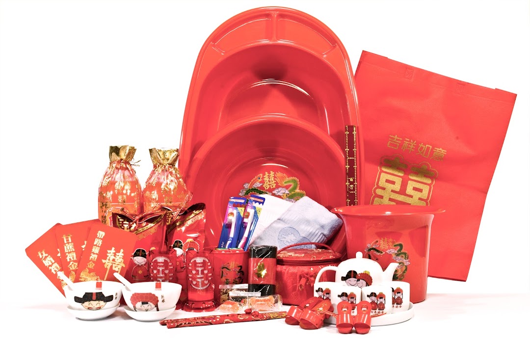 A vibrant collection of red-themed traditional Chinese wedding items, including tea sets, basins, and decor.