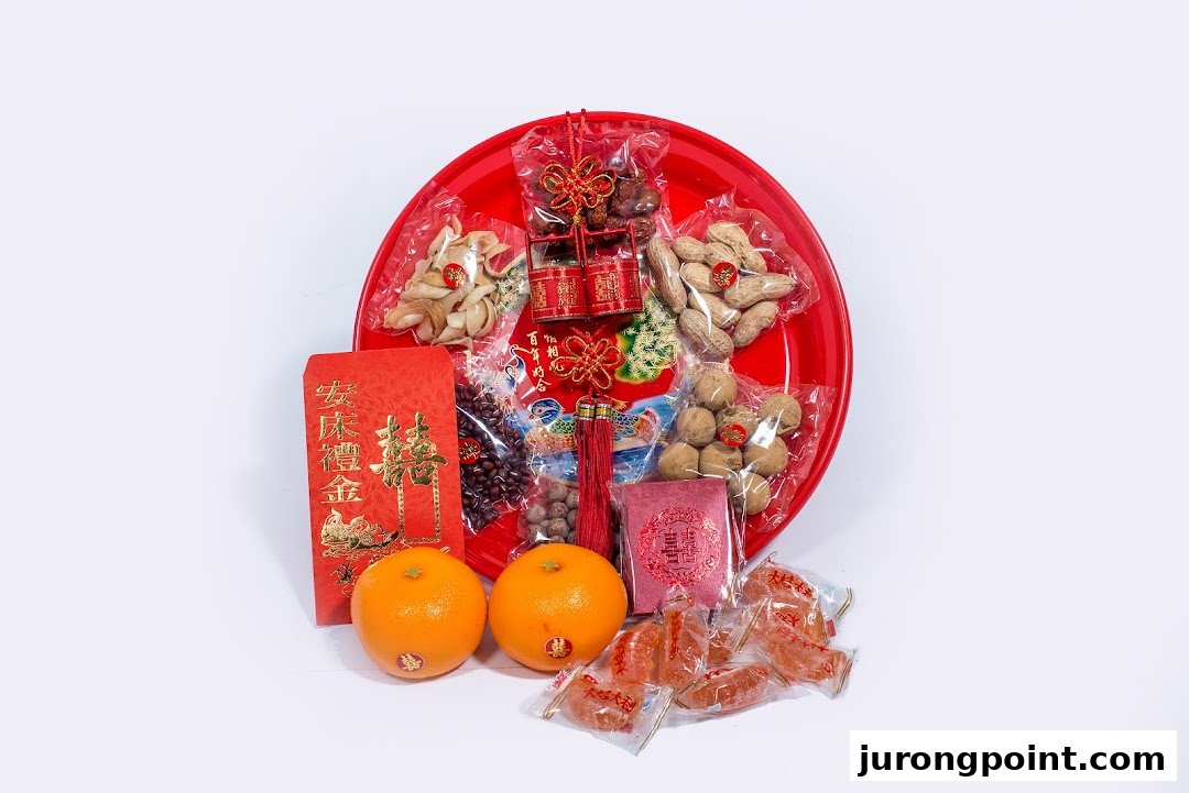 A red tray filled with traditional Chinese wedding items, including nuts, dried fruits, and red packets.