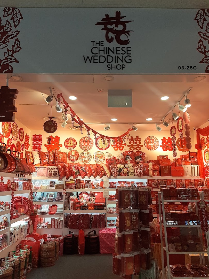 The shopfront of The Chinese Wedding Shop, showcasing a vibrant display of traditional red wedding items.
