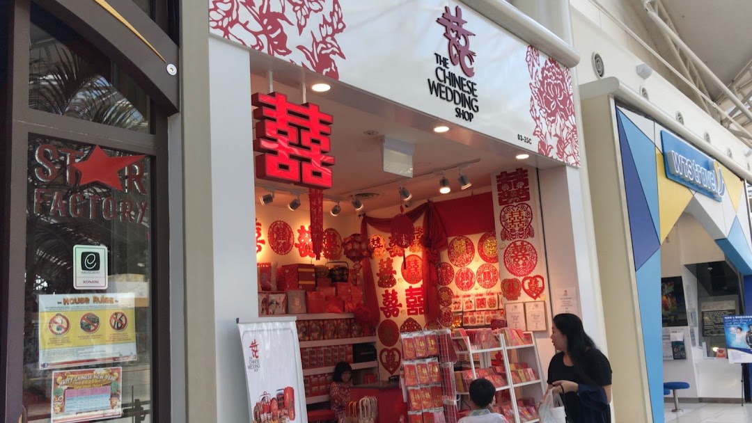 The shop front of The Chinese Wedding Shop, adorned with traditional red decorations and wedding items.
