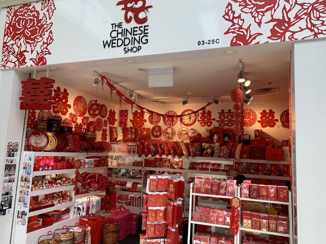 The shop front of 'The Chinese Wedding Shop' displaying traditional red wedding items and decorations.