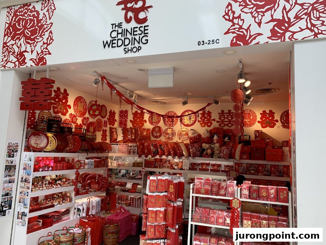 The shop front of 'The Chinese Wedding Shop' displaying traditional red wedding items and decorations.