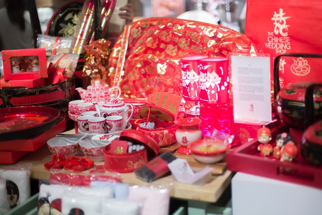 A vibrant display of traditional Chinese wedding items, including tea sets, gifts, and decorations.