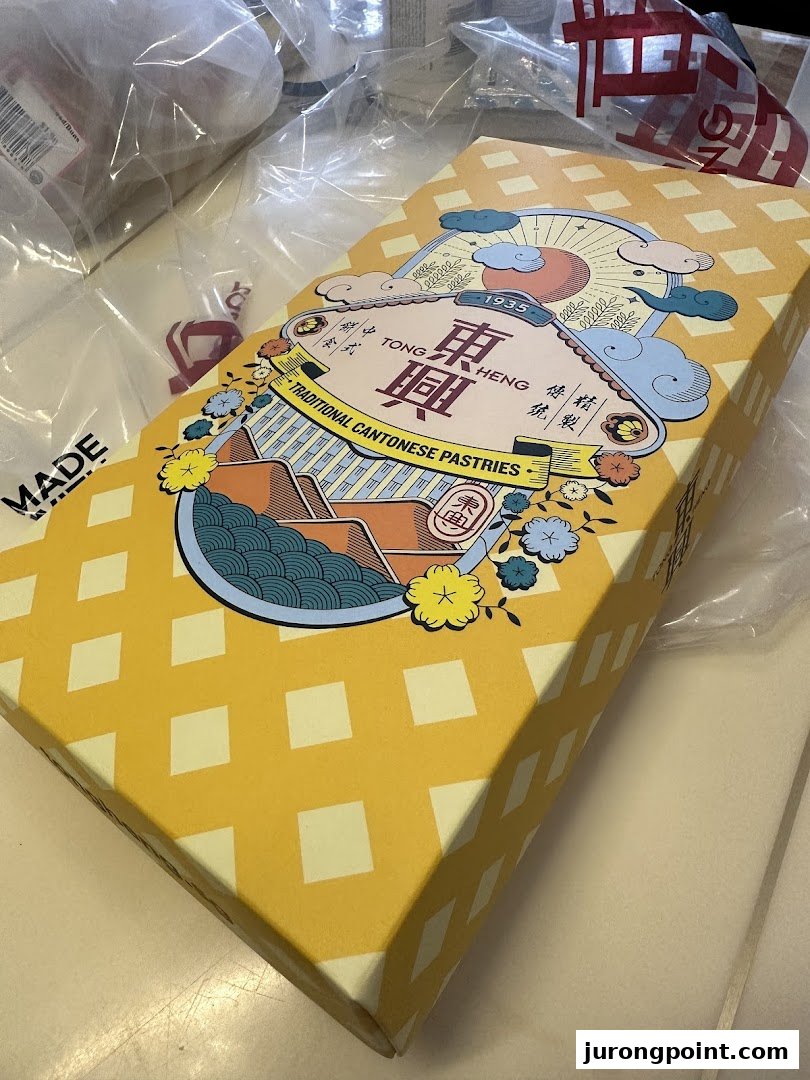 A vibrant yellow box from Tong Heng, featuring traditional Cantonese pastries branding.