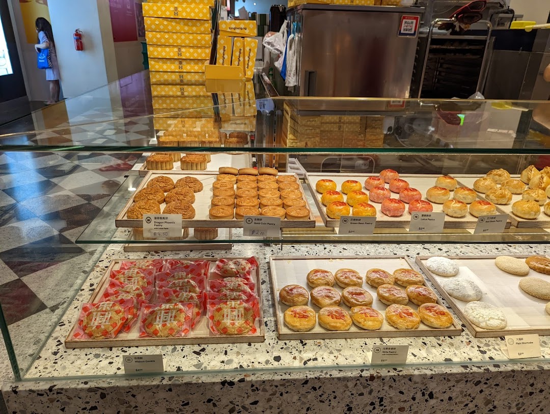 A vibrant display counter showcasing a variety of freshly baked traditional Chinese pastries and cookies at Tong Heng.