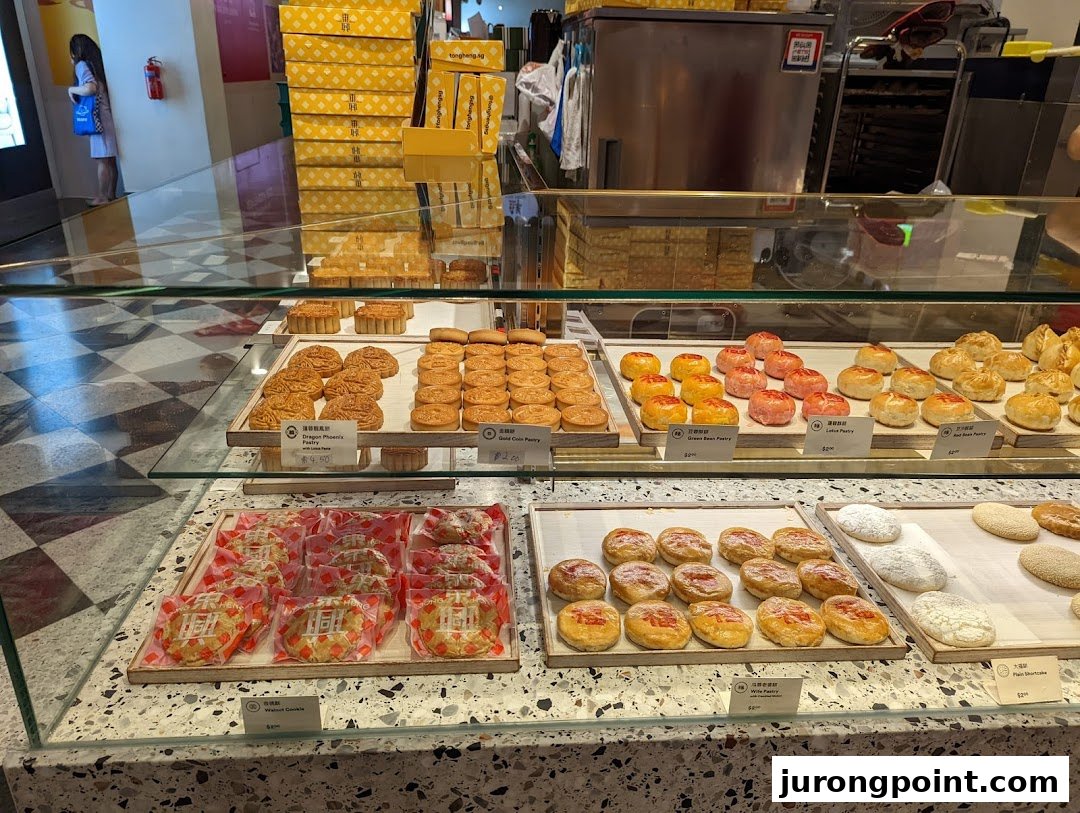 A vibrant display counter showcasing a variety of freshly baked traditional Chinese pastries and cookies at Tong Heng.