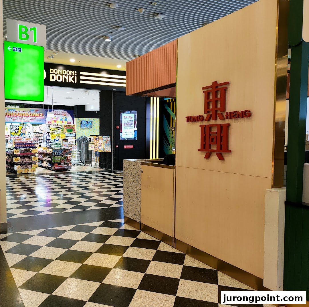 The shop front of Tong Heng bakery with its distinctive red logo, adjacent to Don Don Donki.