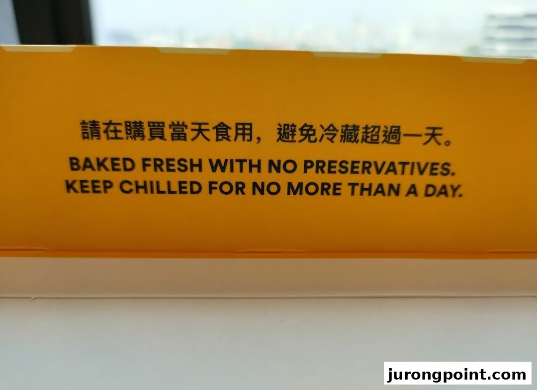 A close-up of a yellow sign or packaging with instructions about product freshness and storage.