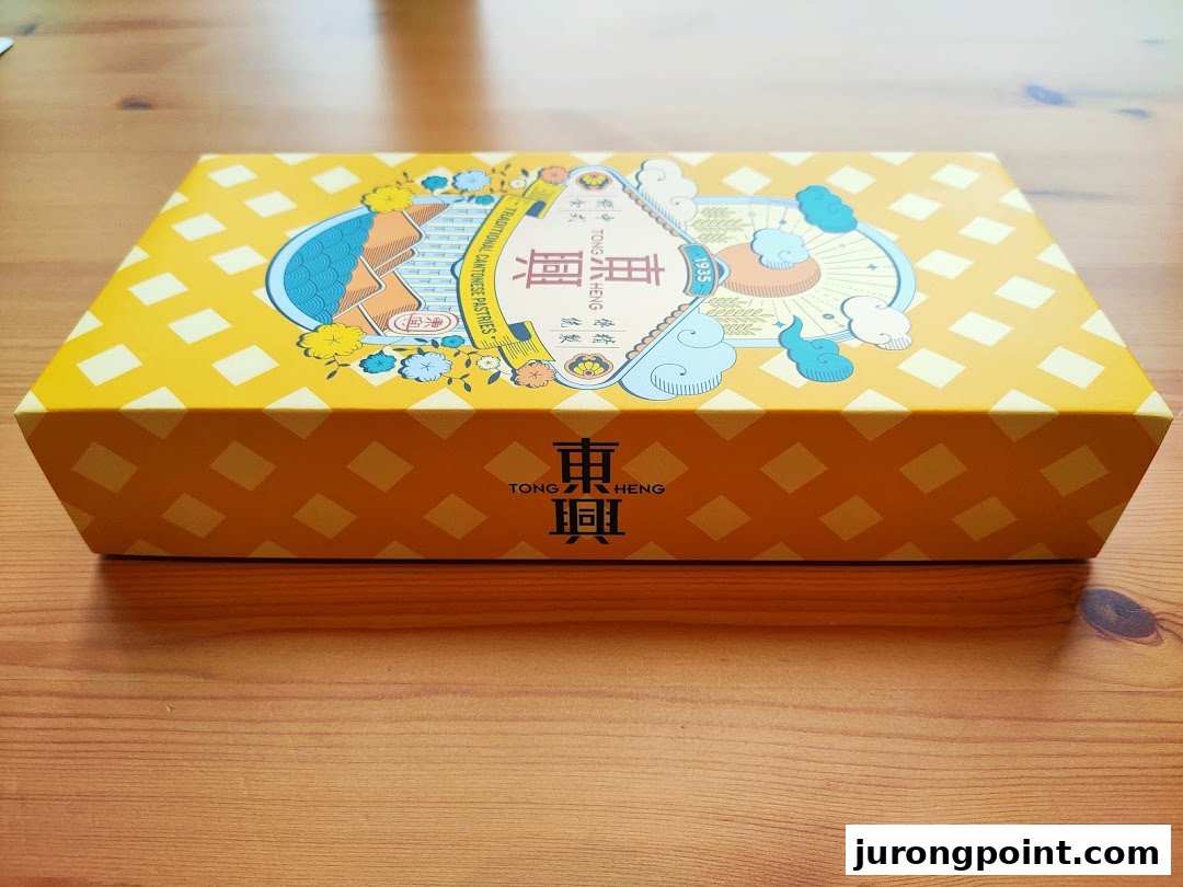 A vibrant yellow Tong Heng gift box featuring traditional Cantonese pastry branding.