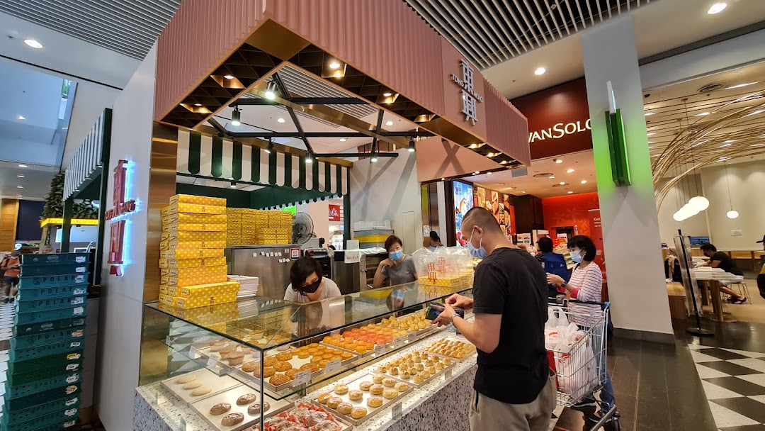 A bustling pastry shop counter showcasing a variety of traditional Chinese baked goods and pastries.