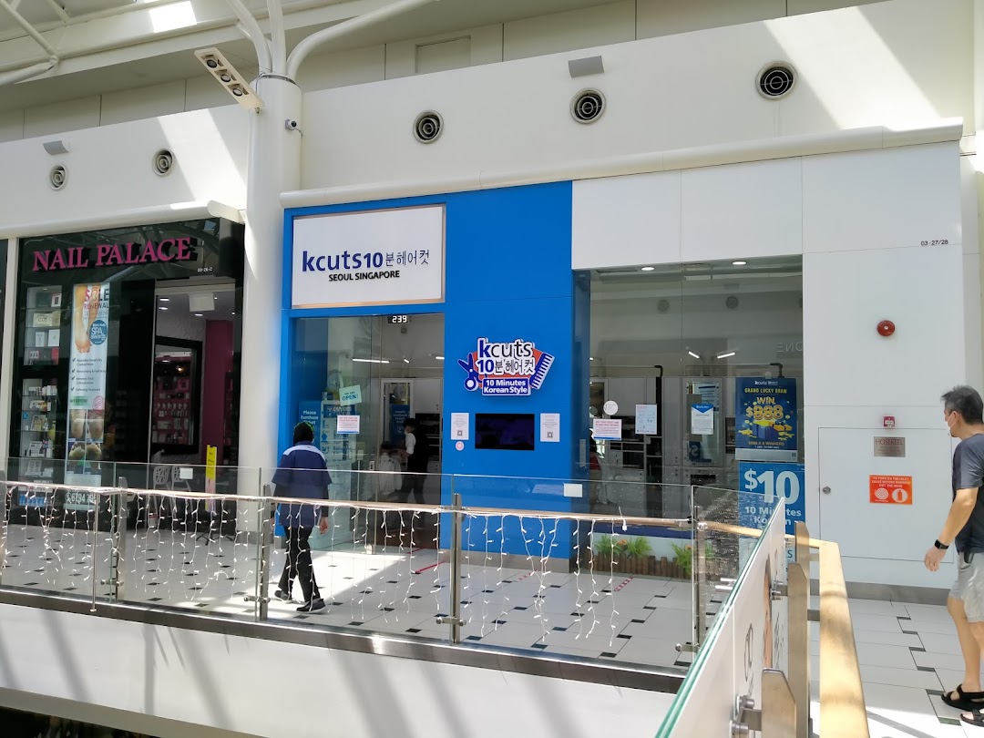The bright blue storefront of kcuts10, a Korean-style haircut salon, located within a shopping mall.