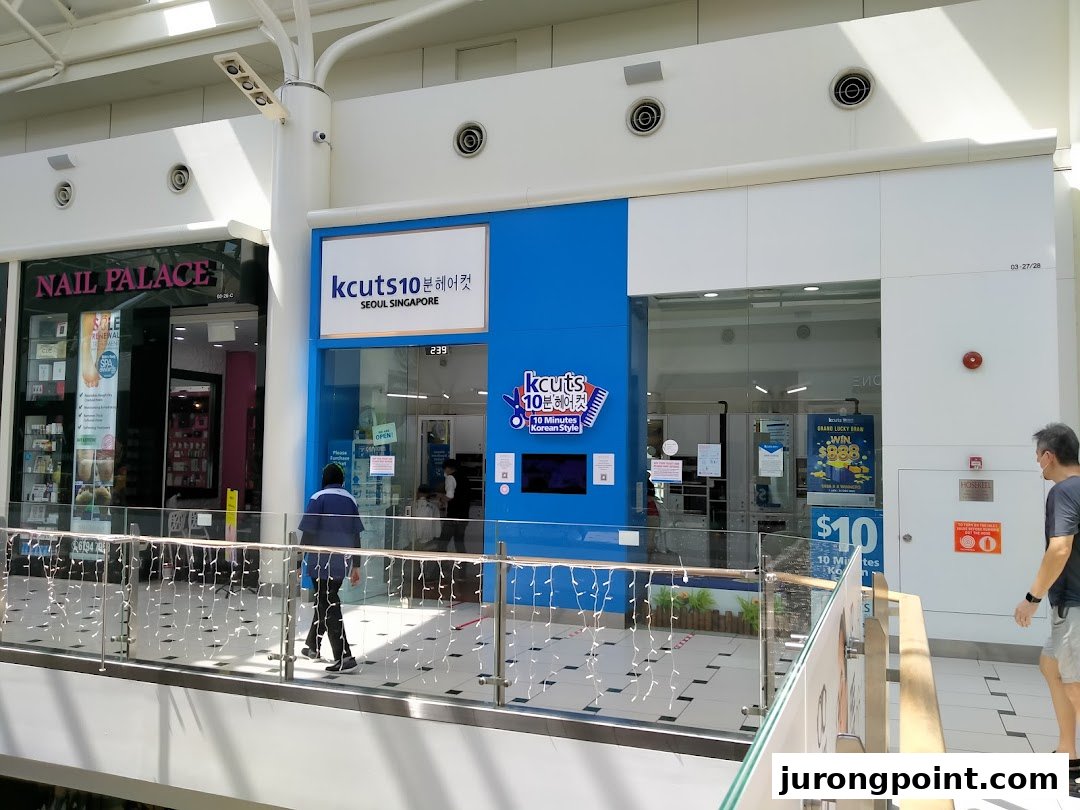 The bright blue storefront of kcuts10, a Korean-style haircut salon, located within a shopping mall.