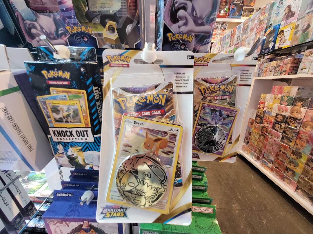 A vibrant display of Pokémon Trading Card Game products, including booster packs and special collections, within a retail store.