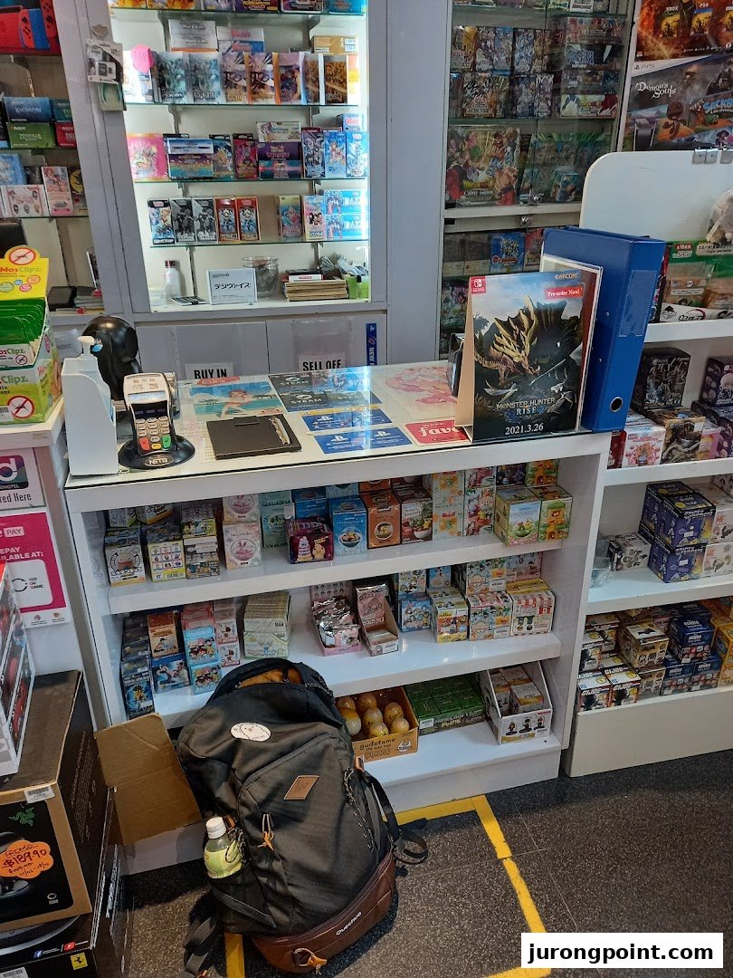An interior view of Toy Or Game TOG, showcasing shelves filled with games, collectibles, and a sales counter.