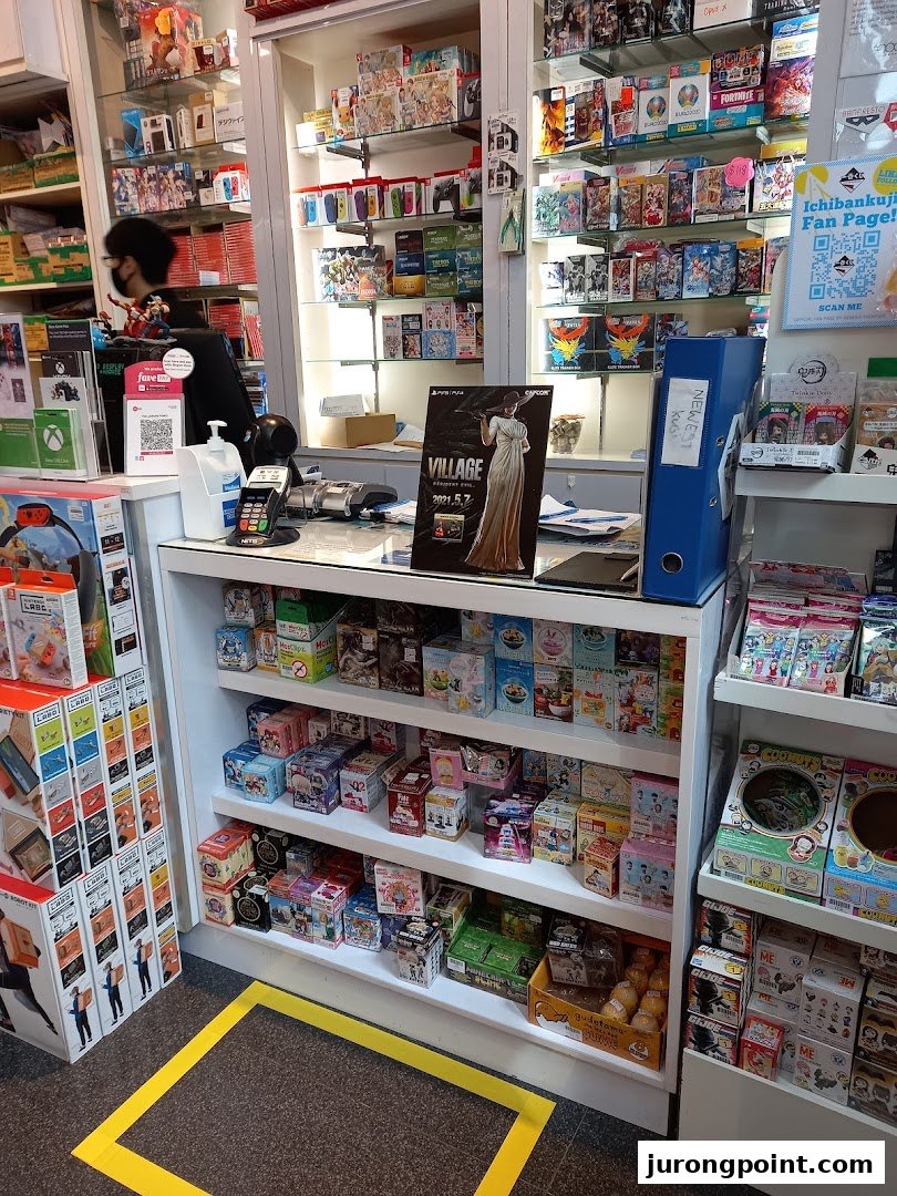 Interior view of Toy Or Game TOG, featuring a counter, shelves filled with games, toys, and collectibles.