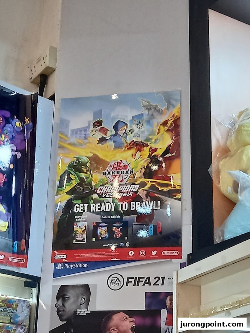 An interior shot of Toy Or Game TOG, featuring vibrant posters for Bakugan and FIFA 21 games.