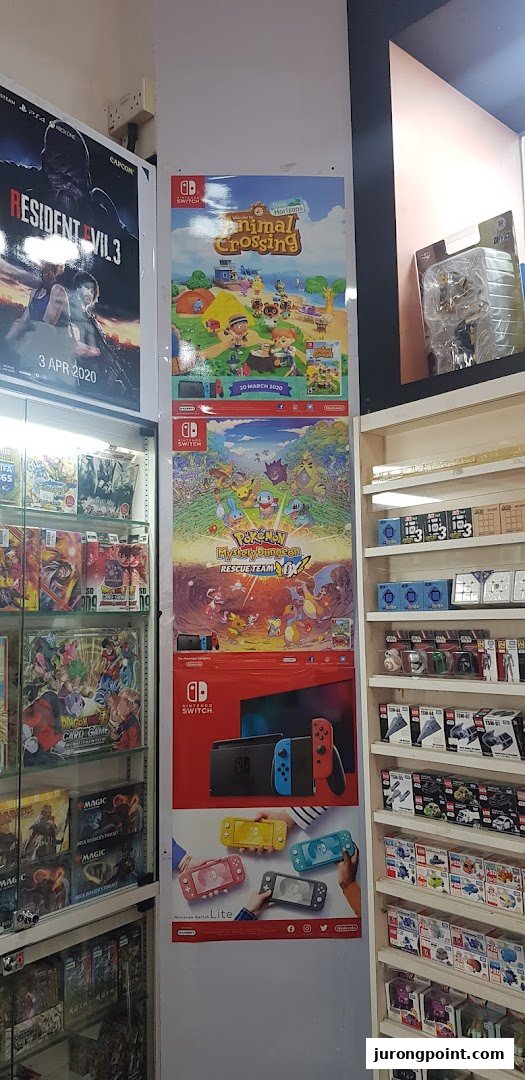 Interior view of a game and toy shop featuring video game posters, consoles, and various collectibles.