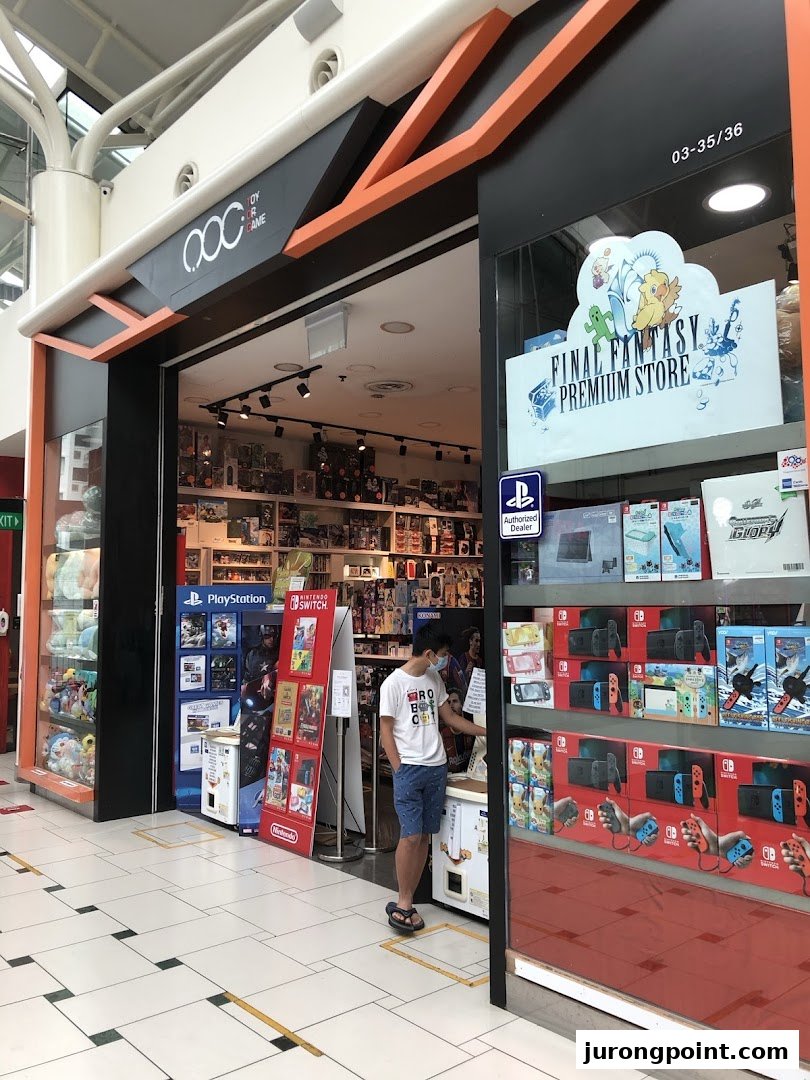 The vibrant storefront of Toy Or Game TOG, showcasing gaming consoles, merchandise, and a Final Fantasy Premium Store display.