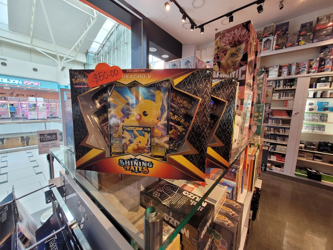 A large Pokemon Pikachu V box display with a $50 price tag, showcasing the interior of a toy and game shop.
