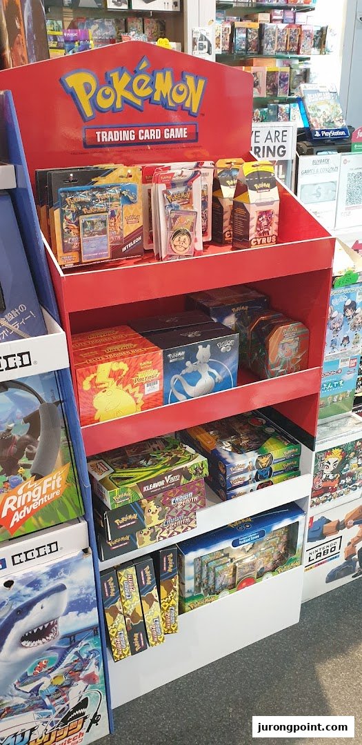 A vibrant in-store display showcasing a wide array of Pokémon Trading Card Game products and other popular games.
