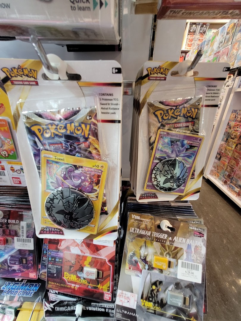 Close-up of Pokémon Trading Card Game and Ultraman merchandise displayed on shelves inside the store.